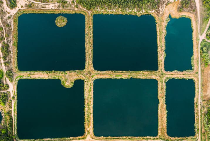 Aerial View Retention Basins, Wet Ponds, Wet Detention Basin Or Stormwater Management Ponds, An Artificial Pond With Vegetation Around The Perimeter, And Includes A Permanent Pool Of Water In Its Design.