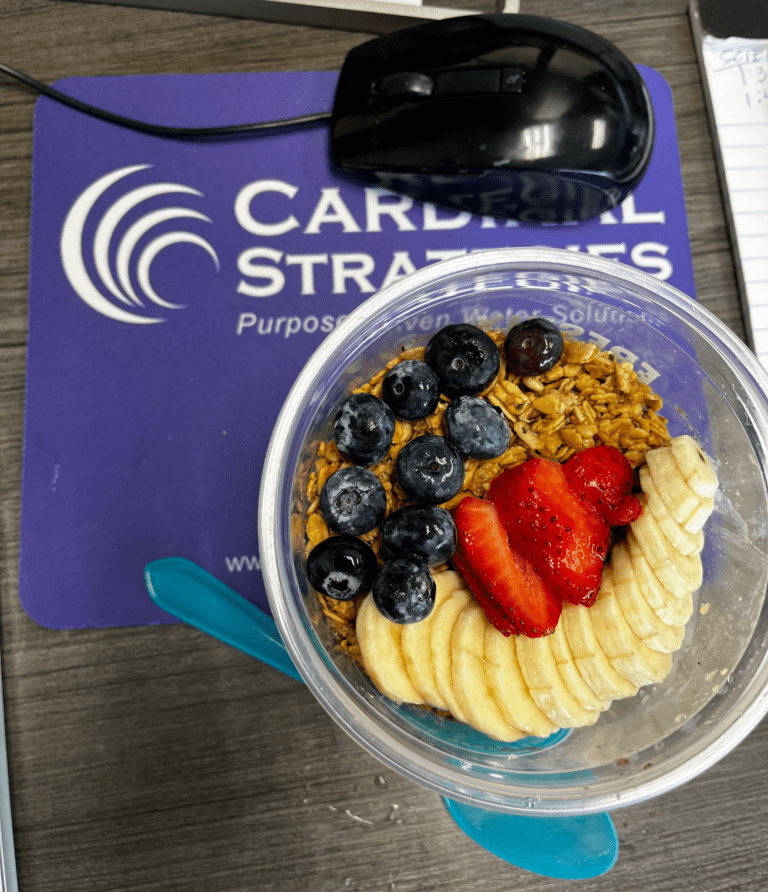 A picture of an Acai bowl on a mouse pad of Cardinal Strategies.
