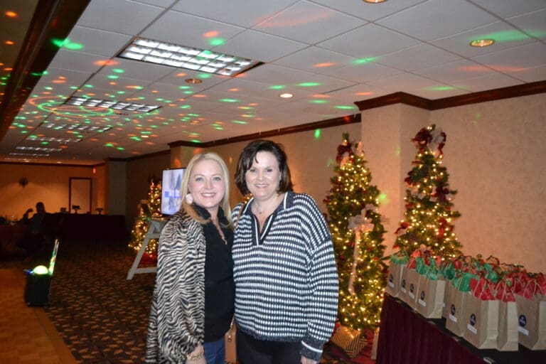 Kim and Lisa from Cardinal Strategies smiling at the company Christmas party.