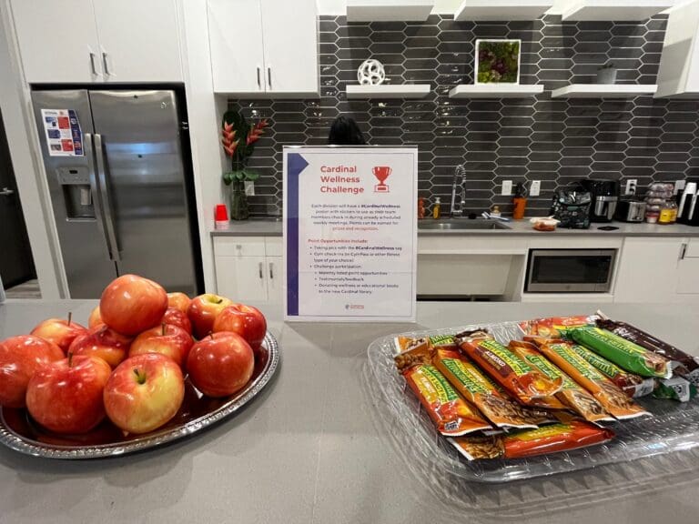 Cardinal Strategies Kitchen with apples and granola bars talking about a wellness