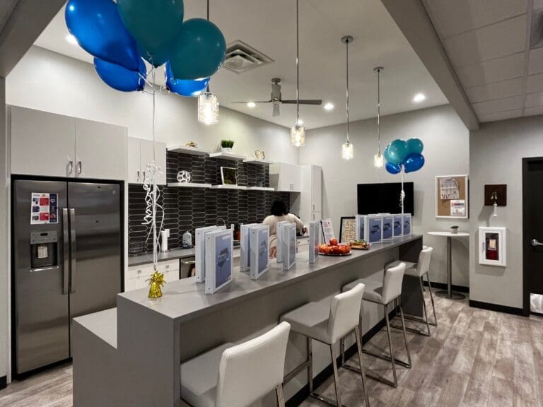 A picture of the Cardinal Strategies kitchen with balloons and binders on the ledge of the counter.