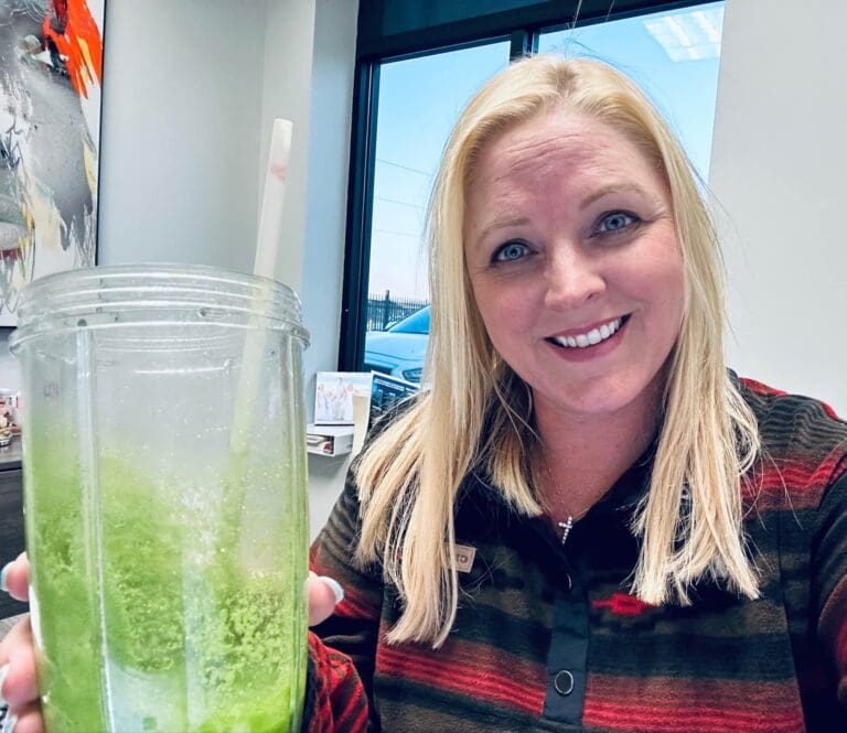 Kim from Cardinal Strategies holding a smoothie.