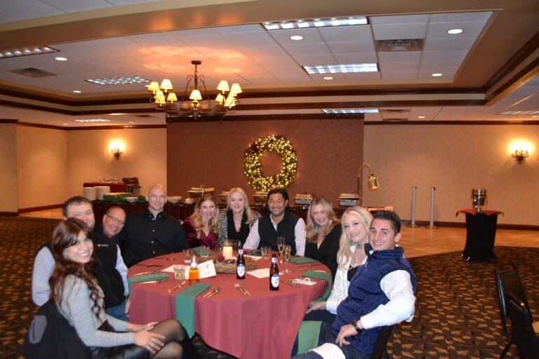 Image of a group of Cardinal Strategies employees at a table for a Christmas party.