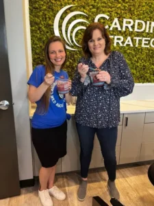 Two women standing holding breakfast bowls