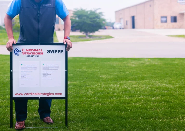 Person putting SWPPP sign in the ground