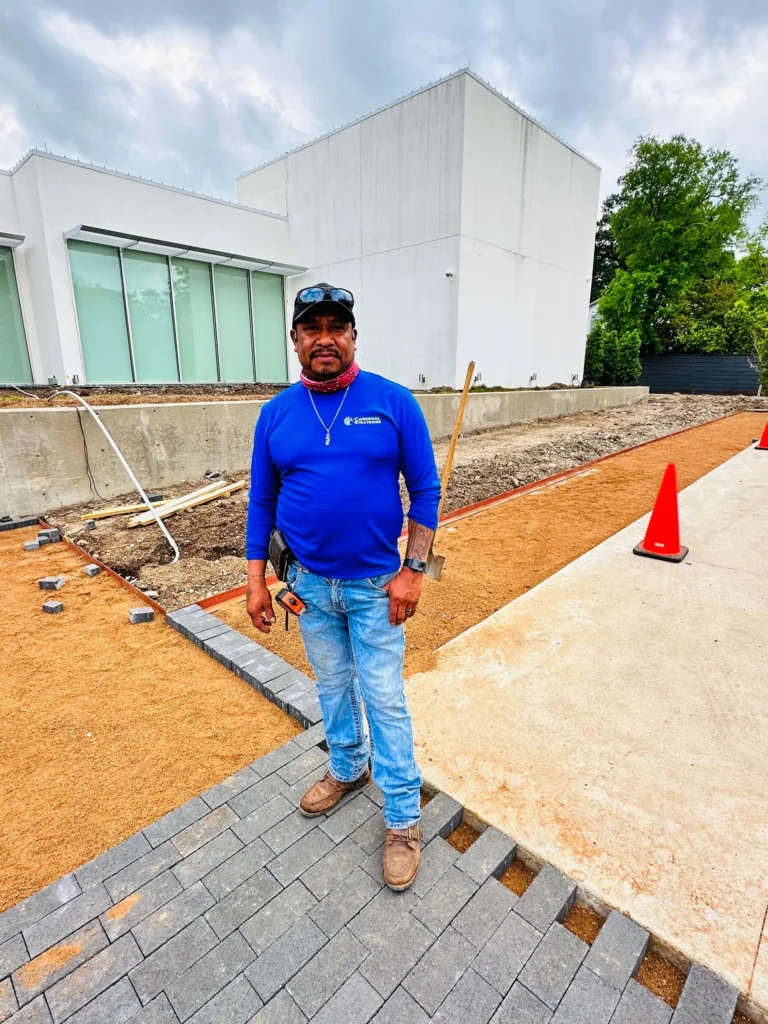 A Cardinal Strategies crew member standing with a hardscape surrounding him.