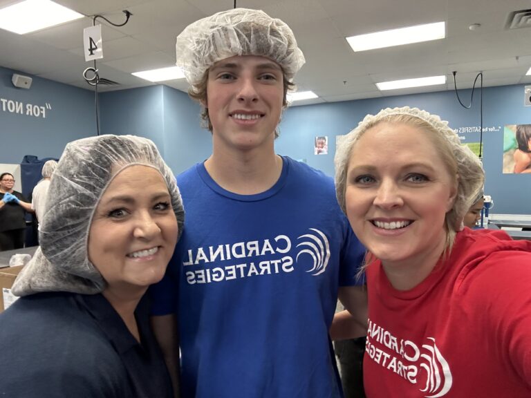 Cardinal staff members in hair nets volunteering at FMSC