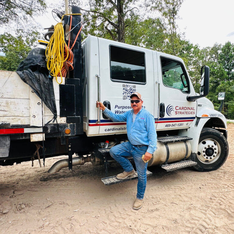 Miguel Sr standing in front of Cardinal Strategies truck